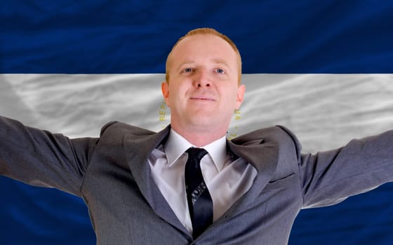 joyful investor spreading arms after good business investment in nicaragua, in front of flag