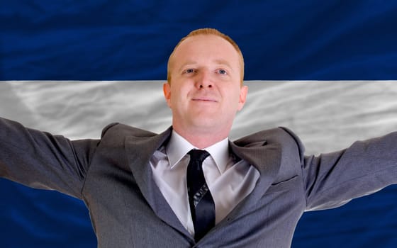 joyful investor spreading arms after good business investment in nicaragua, in front of flag