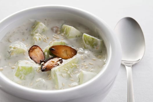 Fresh cold cucumber soup with almonds close up