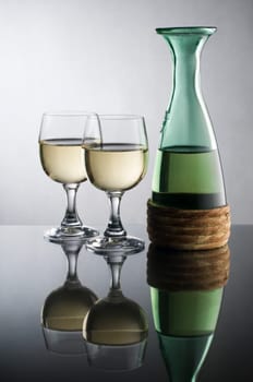 Bottle with white wine and glass close up
