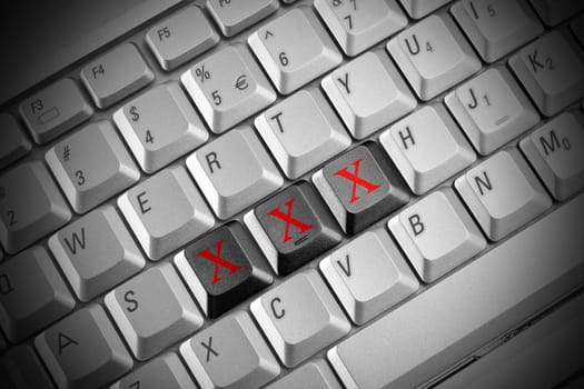 Internet porn concept. xxx buttons on the computer keyboard