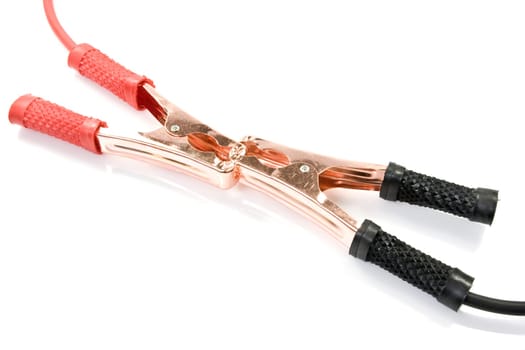 Two jumper cables engaged with their black and red clamp shot over white