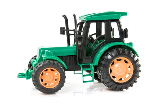 green plastic tractor over a white background