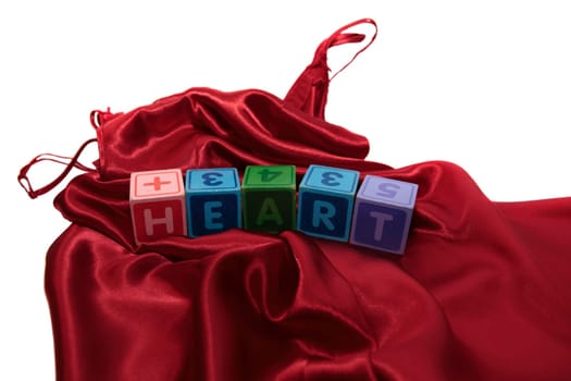 love heart on block on a silk nightie against white background