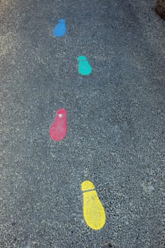 painted footprints on tarmac in infant school playground