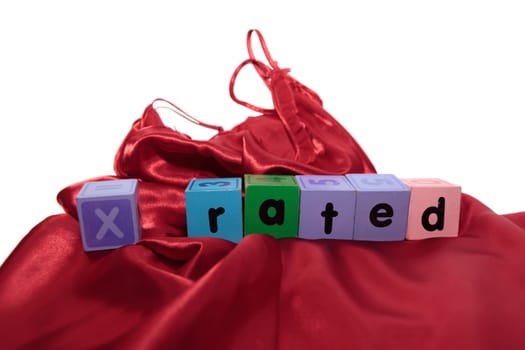 x rated written with blocks on a silk nightie against white background