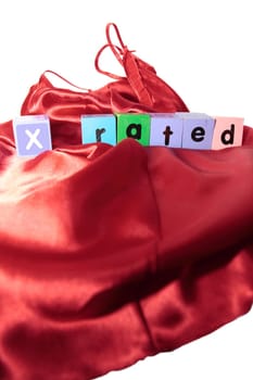 x rated written with blocks on a silk nightie against white background