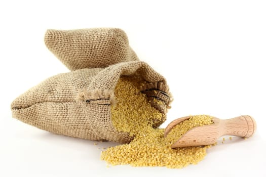 a sack filled with millet against a light background