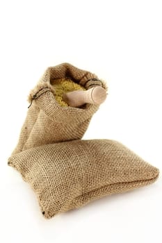 a sack filled with millet against a light background
