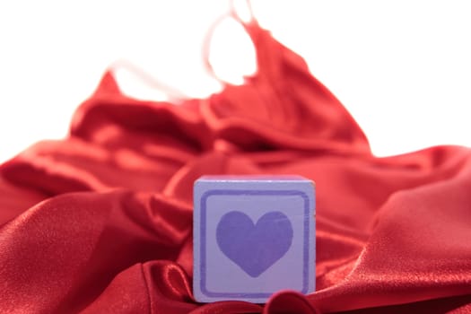love heart on block on a silk nightie against white background