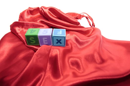 sex written with blocks on a silk nightie against white background