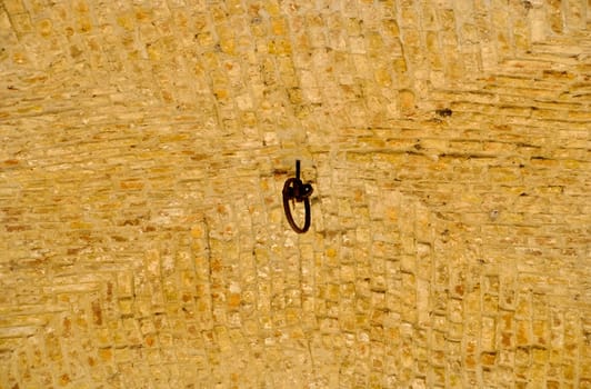 Old stone arched ceiling with a ring in the middle