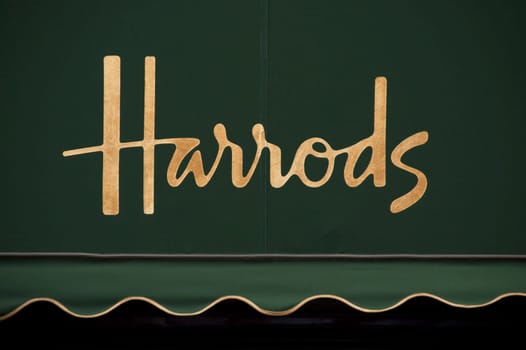 Harrods golden sign on green awning