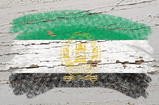 Chalky afghan flag painted with color chalk on grunge wooden texture