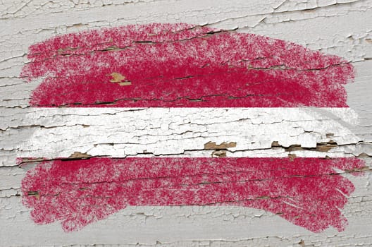 Chalky latvian flag painted with color chalk on grunge wooden texture