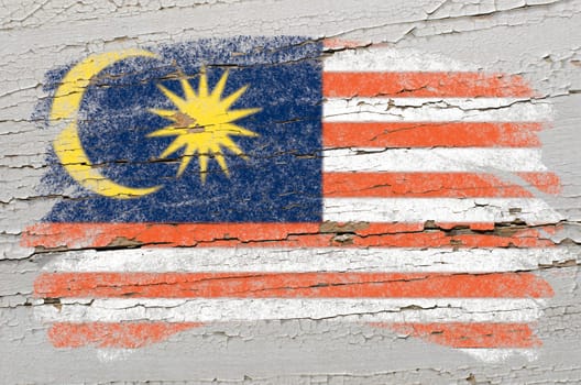 Chalky malaysian flag painted with color chalk on grunge wooden texture