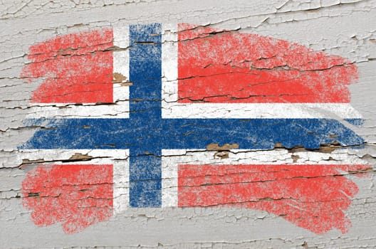 Chalky norwegian flag painted with color chalk on grunge wooden texture