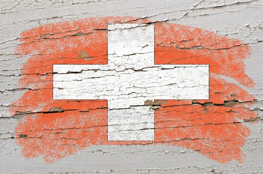 Chalky swiss flag painted with color chalk on grunge wooden texture