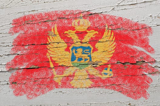 Chalky  montenegrian flag painted with color chalk on grunge wooden texture