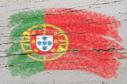 Chalky portugese flag painted with color chalk on grunge wooden texture