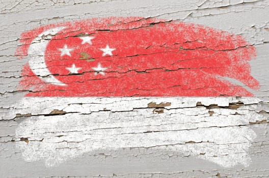 Chalky singapore flag painted with color chalk on grunge wooden texture