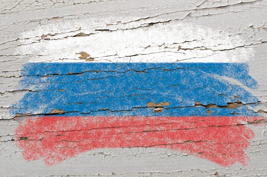 Chalky russian flag painted with color chalk on grunge wooden texture