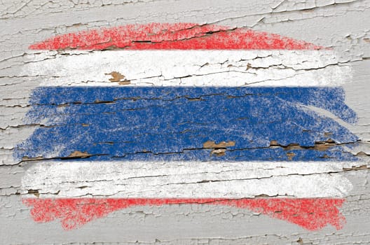 Chalky thai flag painted with color chalk on grunge wooden texture