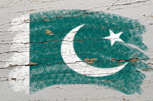 Chalky pakistan flag painted with color chalk on grunge wooden texture