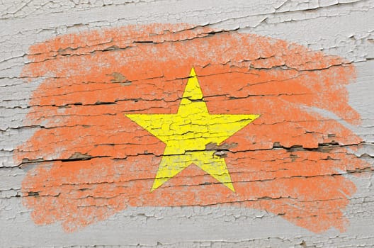 Chalky vietnamese flag painted with color chalk on grunge wooden texture