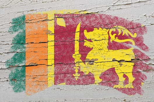 Chalky srilankan flag painted with color chalk on grunge wooden texture