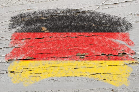 Chalky german flag painted with color chalk on grunge wooden texture