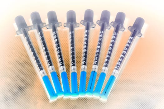 Shaded insulin injection pen laying on studio ground