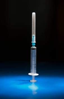 Empty and isolated medical syringe standing head up