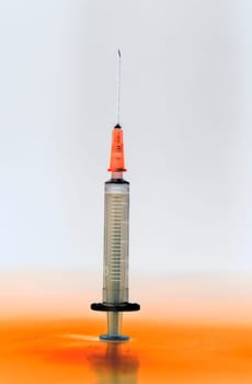 Shaded and ready medical syringe standing head up