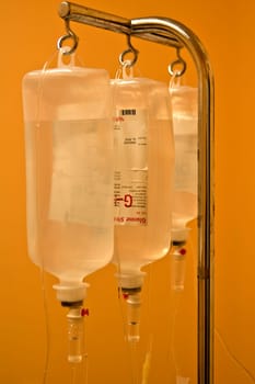 Infusion bottles hanging on metal holder in line