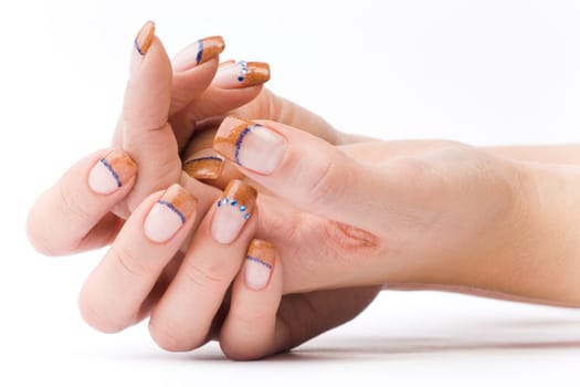 Beautiful female well-groomed colorful fingernails against white background