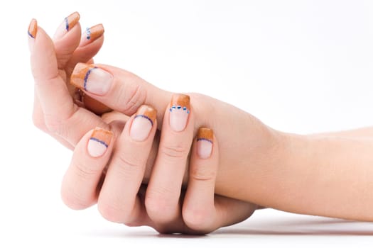 Beautiful female well-groomed colorful fingernails against white background