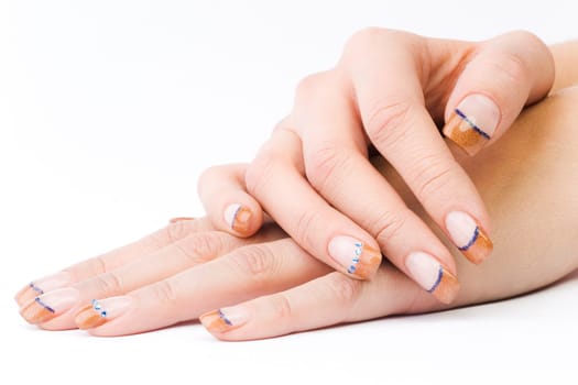 Beautiful female well-groomed colorful fingernails against white background