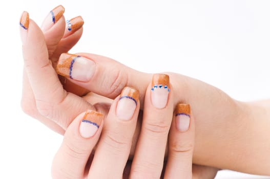 Beautiful female well-groomed colorful fingernails against white background