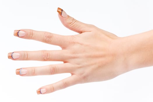 Beautiful female well-groomed colorful fingernails against white background