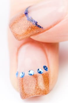 Beautiful female well-groomed colorful fingernails against white background