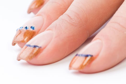 Beautiful female well-groomed colorful fingernails against white background