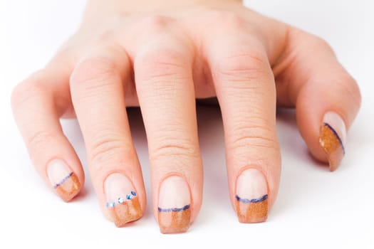 Beautiful female well-groomed colorful fingernails against white background