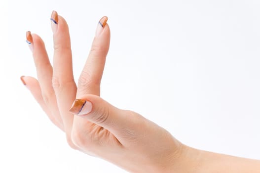Beautiful female well-groomed colorful fingernails against white background