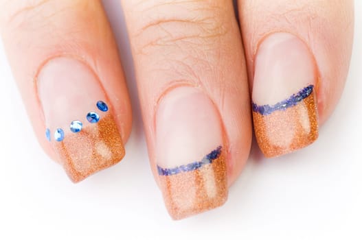 Beautiful female well-groomed colorful fingernails against white background