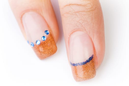 Beautiful female well-groomed colorful fingernails against white background
