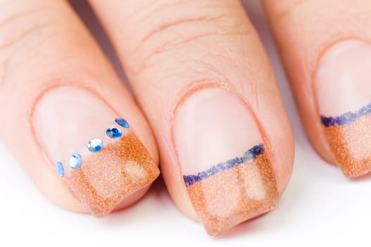 Beautiful female well-groomed colorful fingernails against white background