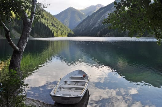 Boat on peaceful lake in mountain landscape