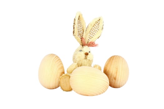 Easter straw rabbit and wooden egg isolated on white
