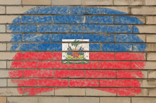 Chalky haitian flag painted with color chalk on grunge old brick wall